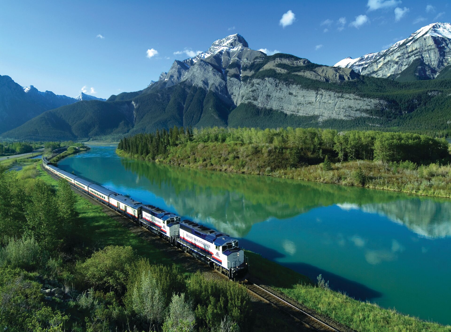 Turquoise lake surrounded by massive, snow-capped mountains in Canada.